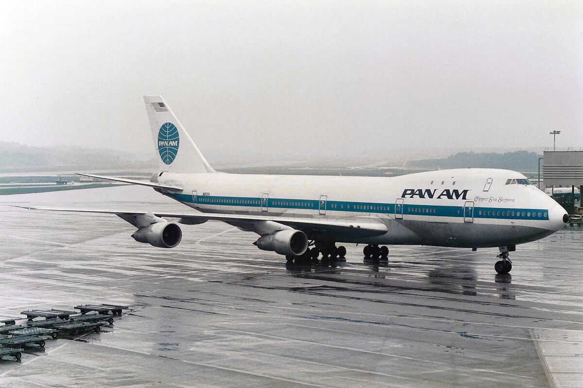 Dramatic silhouette of an airplane flying against a vibrant sunset sky.